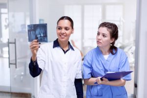 Dentist and team looking at x-ray images